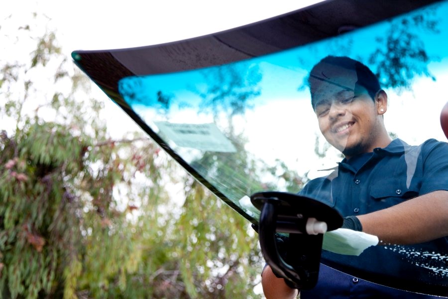 A person in uniform holding a windshield